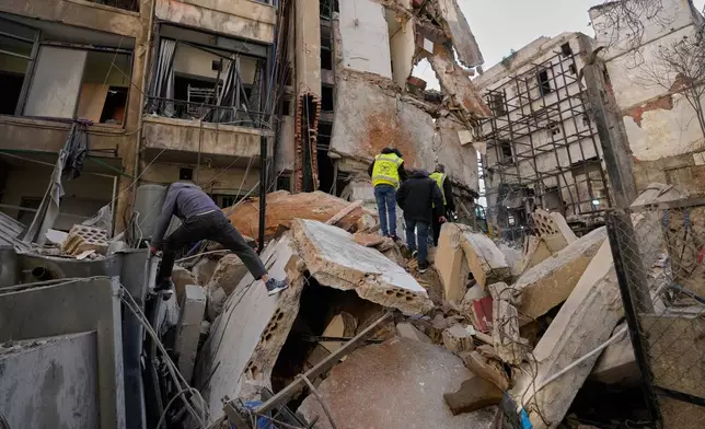 People inspect the rubble of a building destroyed in an Israeli airstrike a day earlier in Beirut, Lebanon, Thursday, April 9, 2026. (AP Photo/Hussein Malla)