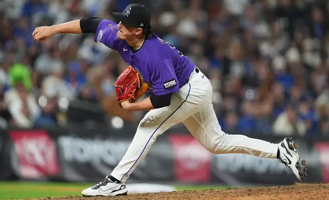 Colorado Rockies relief pitcher Victor Vodnik works against the Los Angeles Dodgers in the ninth inning of a baseball game Saturday, April 18, 2026, in Denver. (AP Photo/David Zalubowski)
