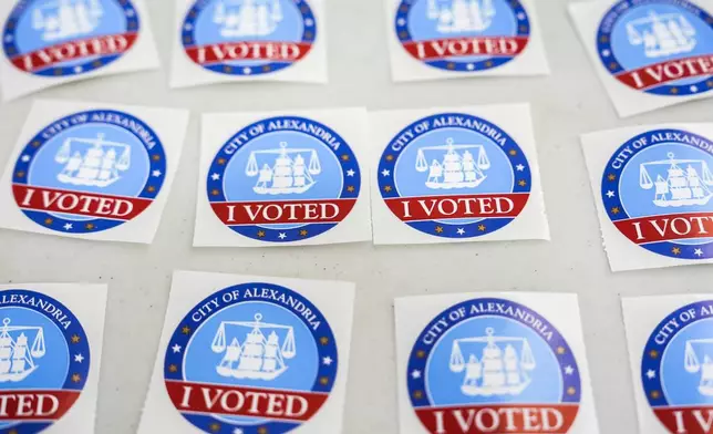 "I Voted" stickers are laid out on a table at Lyles-Crouch Traditional Academy on election day for the Virginia redistricting referendum, Tuesday, April 21, 2026, in Alexandria, Va. (AP Photo/Julia Demaree Nikhinson)