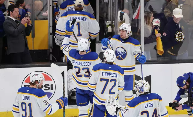 The Buffalo Sabres celebrate as they leave the ice after defeating the Boston Bruins in Game 4 of a first-round NHL hockey Stanley Cup playoff series, Sunday, April 26, 2026, in Boston. (AP Photo/Michael Dwyer)