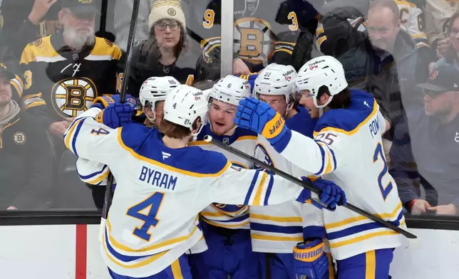 Buffalo Sabres' Zach Benson (6) celebrates his goal with teammates Bowen Byram (4), Noah Ostlund (86), Josh Doan (91) and Owen Power (25) during the first period in Game 4 of a first-round NHL hockey Stanley Cup playoff series against the Boston Bruins, Sunday, April 26, 2026, in Boston. (AP Photo/Michael Dwyer)