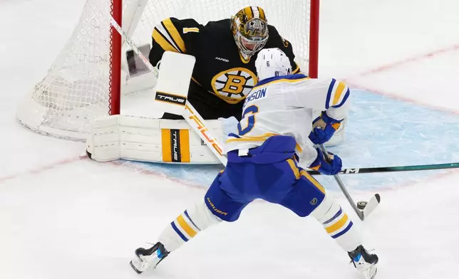 Buffalo Sabres' Zach Benson (6) scores on Boston Bruins' Jeremy Swayman (1) during the first period in Game 4 of a first-round NHL hockey Stanley Cup playoff series, Sunday, April 26, 2026, in Boston. (AP Photo/Michael Dwyer)