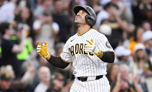 San Diego Padres' Ramón Laureano (5) looks skyward after hitting a three-run home run during the fourth inning of a baseball game against the Colorado Rockies Saturday, April 11, 2026, in San Diego. (AP Photo/Denis Poroy)