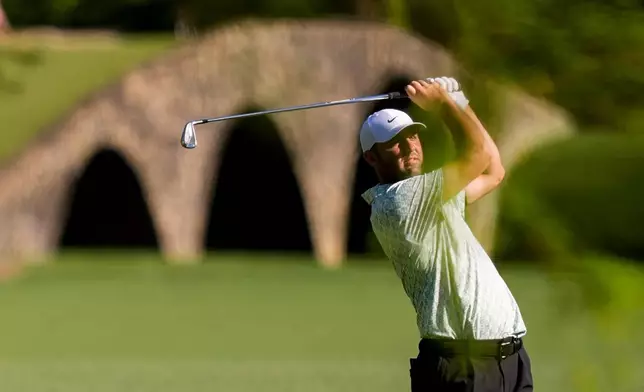 Scottie Scheffler hits from the fairway on the 13th hole during the first round of the Masters golf tournament at the Augusta National Golf Club, Thursday, April 9, 2026, in Augusta, Ga. (AP Photo/David J. Phillip)