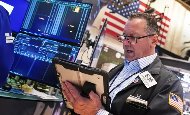 Trader Edward Curran works on the floor of the New York Stock Exchange, Wednesday, April 22, 2026. (AP Photo/Richard Drew)