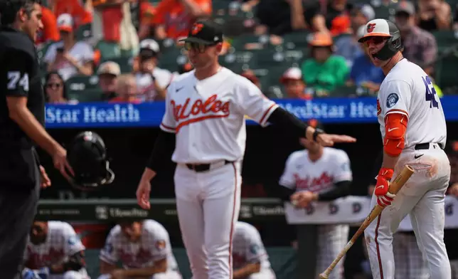 Baltimore Orioles' Pete Alonso, right, yells at umpire John Tumpane (74) as Orioles manager Craig Albernaz, center, intervenes after Alonso was called out on an automatic strike due to a batter pitch time violation in the seventh inning of a baseball game against the Arizona Diamondbacks, Wednesday, April 15, 2026, in Baltimore. (AP Photo/Stephanie Scarbrough)