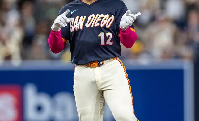 San Diego Padres' Luis Campusano celebrates hitting a double in the third inning of a baseball game against the Colorado Rockies, Friday, April 10, 2026, in San Diego. (AP Photo/Tony Ding)