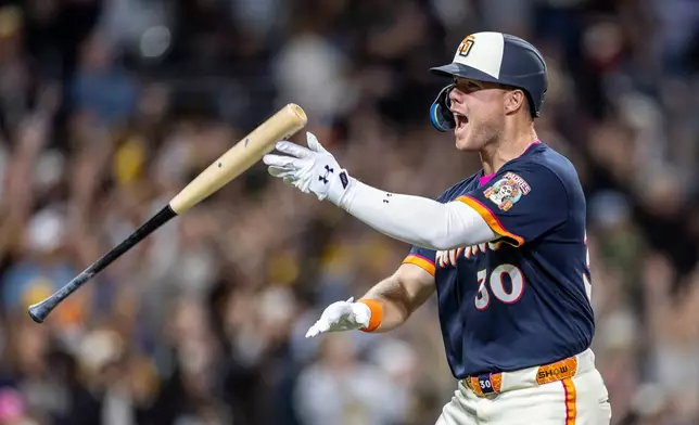 San Diego Padres' Gavin Sheets celebrates hitting a home run in the ninth inning of a baseball game against the Colorado Rockies, Friday, April 10, 2026, in San Diego. (AP Photo/Tony Ding)