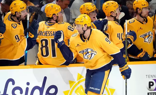 Nashville Predators center Steven Stamkos (91) is congratulated after scoring against the Minnesota Wild during the first period of an NHL hockey game Saturday, April 11, 2026, in Nashville, Tenn. (AP Photo/Mark Humphrey)
