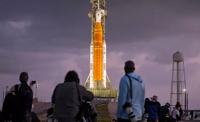 Photographers set up remote cameras near NASA's Artermis II moon rocket on Launch Pad 39-B just before sunrise at the Kennedy Space Center Tuesday, March 31, 2026, in Cape Canaveral, Fla. (AP Photo/Chris O'Meara)