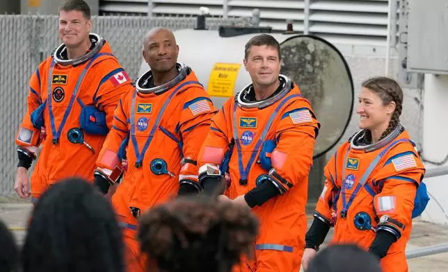 Astronauts, from left, Mission Specialist Jeremy Hansen, of Canada,, Pilot Victor Glover, Commander Reid Wiseman, and Mission Specialist Christina Koch pose for a photo after leaving the Operations and Checkout Building for a trip to Launch Pad 39-B and a planned liftoff on NASA's Artemis II moon rocket at the Kennedy Space Center Wednesday, April 1, 2026, in Cape Canaveral, Fla. (AP Photo/Chris O'Meara)