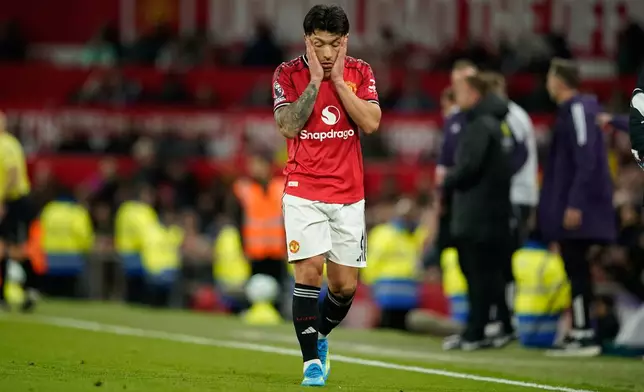 Manchester United's Lisandro Martinez reacts after receiveng a red card during the Premiier League soccer match between Manchester United and Leeds in Manchester, England, Monday, April 13, 2026. (AP Photo/Dave Thompson)