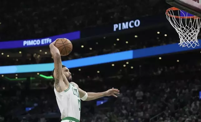 Boston Celtics forward Jayson Tatum goes in for a dunk against the Philadelphia 76ers during the first half in Game 1 of a first-round NBA playoffs basketball game, Sunday, April 19, 2026, in Boston. (AP Photo/Robert F. Bukaty)
