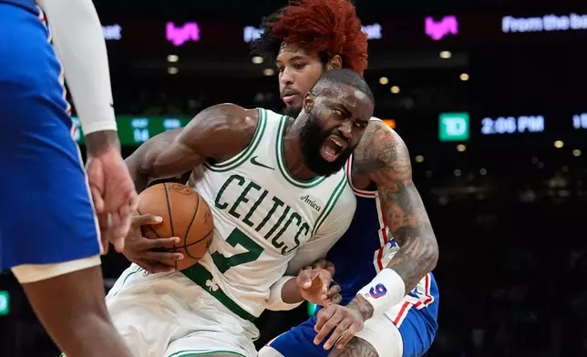 Boston Celtics guard Jaylen Brown (7) drives against Philadelphia 76ers guard Kelly Oubre Jr. (9) during the first half in Game 1 of a first-round NBA playoffs basketball game, Sunday, April 19, 2026, in Boston. (AP Photo/Robert F. Bukaty)