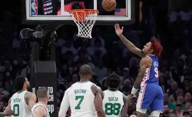 Boston Celtics guard Derrick White (9) goes for a layup against the Boston Celtics during the first half in Game 1 of a first-round NBA playoffs basketball game, Sunday, April 19, 2026, in Boston. (AP Photo/Robert F. Bukaty)