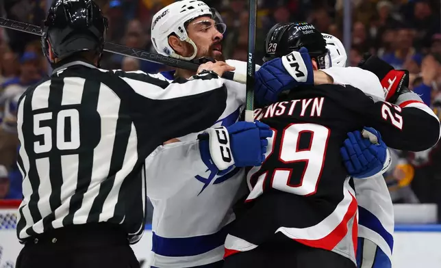 Tampa Bay Lightning left wing Nick Paul, second from left, is separated from Buffalo Sabres left wing Beck Malenstyn (29) during the first period of an NHL hockey game Monday, April 6, 2026, in Buffalo, N.Y. (AP Photo/Jeffrey T. Barnes)