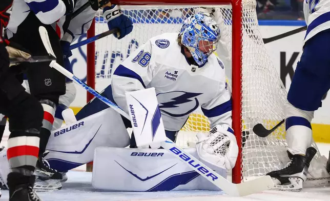 Tampa Bay Lightning goaltender Andrei Vasilevskiy (88) looks for the puck in traffic during the first period of an NHL hockey game against the Buffalo Sabres, Monday, April 6, 2026, in Buffalo, N.Y. (AP Photo/Jeffrey T. Barnes)