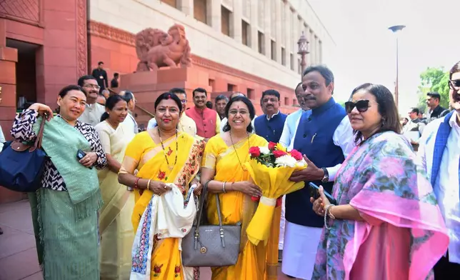 Indian women lawmakers pose outside Parliament House before the start of the debate on a landmark bill to reserve one-third of seats for women, in New Delhi, India, Thursday, April 16, 2026. (AP Photo)