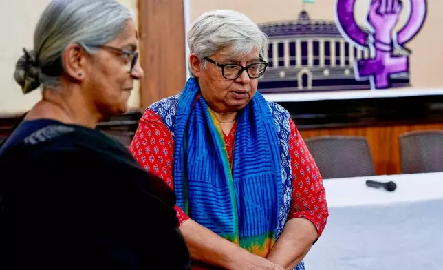 Communist Party of India member Annie Raja, left, and activist Shabnam Hashmi have a chat before a press conference on sending a petition on women's reservation to the parliamentarians in New Delhi, India, Thursday, April 16, 2026. (AP Photo/Manish Swarup)