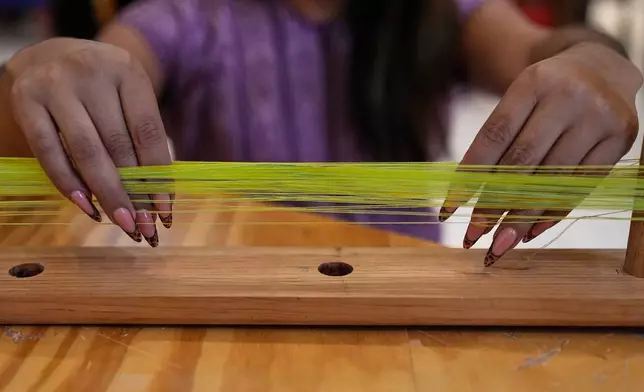 Muxe artist Xaneri Merino gives a backstrap loom workshop for LGBTQ+ people in Mexico City, Tuesday, April 14, 2026. (AP Photo/Marco Ugarte)