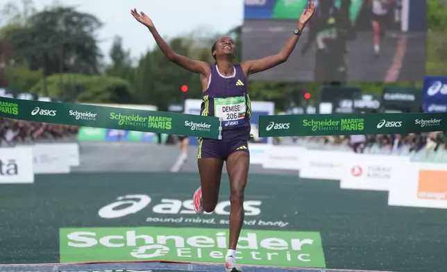 Ethiopia's Shure Demise crosses the finish line to win the women's race of the Paris marathon, in Paris, Sunday, April 12, 2026. (AP Photo/Thibault Camus)