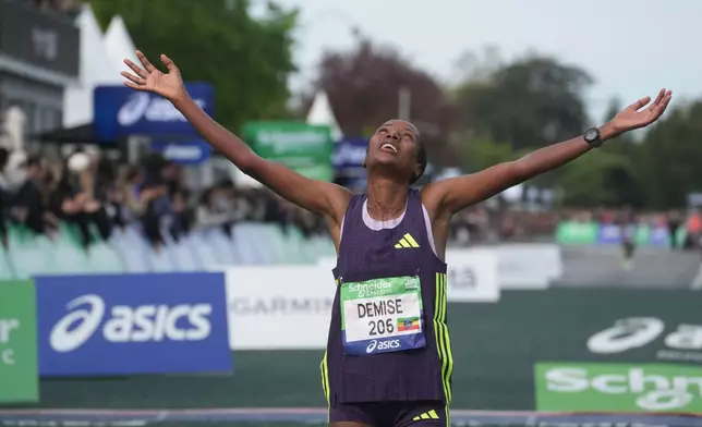Ethiopia's Shure Demise crosses the finish line to win the women's race of the Paris marathon, in Paris, Sunday, April 12, 2026. (AP Photo/Thibault Camus)