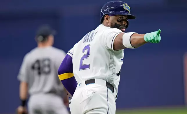Tampa Bay Rays' Yandy Díaz points into the dugout after his two-run home run off New York Yankees pitcher Luis Gil during the first inning of a baseball game Friday, April 10, 2026, in St. Petersburg, Fla. (AP Photo/Chris O'Meara)