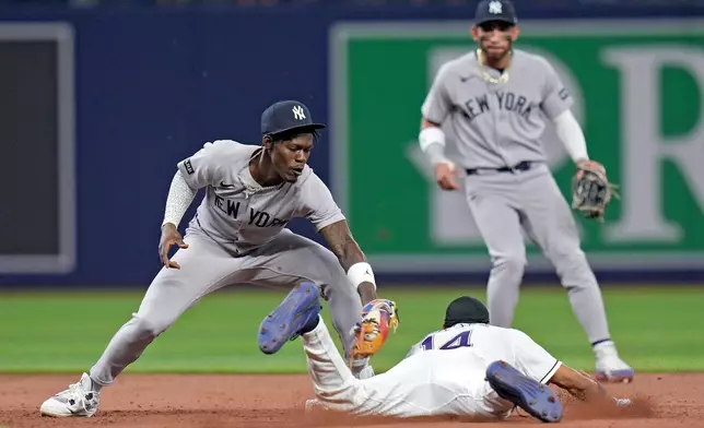 New York Yankees second baseman Jazz Chisholm Jr. tags out Tampa Bay Rays' Chandler Simpson (14) attempting to steal second base during the eighth inning of a baseball game Friday, April 10, 2026, in St. Petersburg, Fla. (AP Photo/Chris O'Meara)