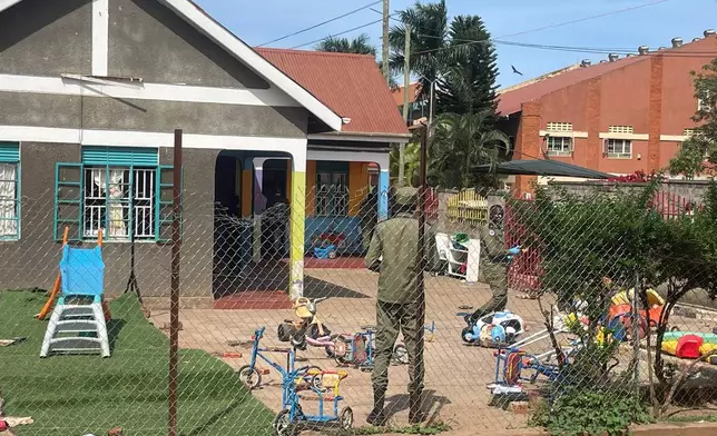 Uganda police officers stand at the crime scene after a man killed four children in a machete attack at the Gaba Early Childhood Development Program nursery school in Kampala, Uganda, Thursday, April 2, 2026. (AP Photo)