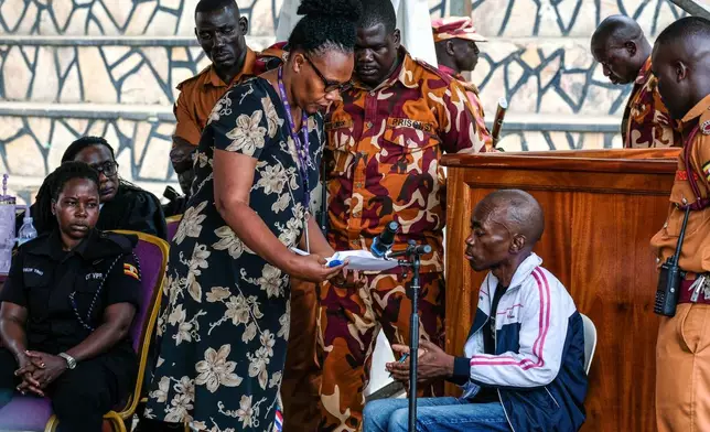 Christopher Okello Onyum, a man accused of killing four children, appears in court at the Ggaba Community Church grounds in Kampala, Uganda, Monday, April 13, 2026. (AP Photo/Hajarah Nalwadda)