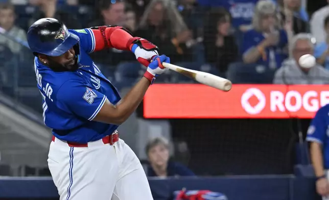 Toronto Blue Jays designated hitter Vladimir Guerrero Jr. hits an RBI single against the Cleveland Guardians in first-inning baseball game action in Toronto, Sunday, April 26, 2026. (Jon Blacker/The Canadian Press via AP)