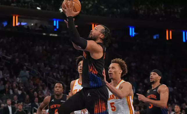New York Knicks' Jalen Brunson drives past Atlanta Hawks' Dyson Daniels (5) during the first half in Game 5 of a first-round NBA playoffs basketball series, Tuesday, April 28, 2026, in New York. (AP Photo/Frank Franklin II)