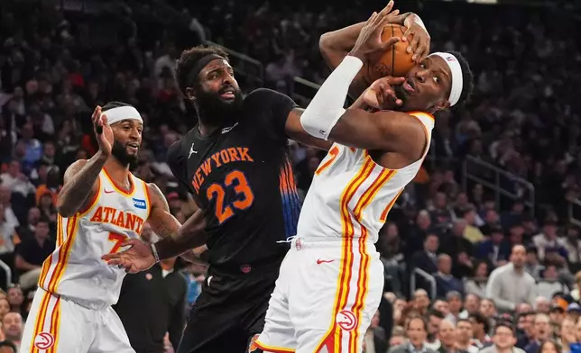 Atlanta Hawks' Nickeil Alexander-Walker (7) fights for control of the ball with New York Knicks' Mitchell Robinson (23) during the first half in Game 5 of a first-round NBA playoffs basketball series, Tuesday, April 28, 2026, in New York. (AP Photo/Frank Franklin II)