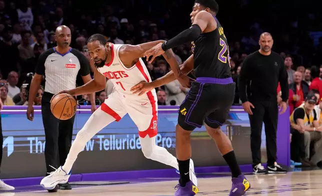 Houston Rockets forward Kevin Durant, left, drives by Los Angeles Lakers forward Rui Hachimura during the first half in Game 2 of a first-round NBA playoffs basketball series Tuesday, April 21, 2026, in Los Angeles. (AP Photo/Mark J. Terrill)