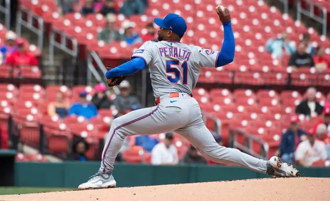 New York Mets' pitcher Freddy Peralta throws during the first inning of a baseball game against the St. Louis Cardinals, Wednesday, April 1, 2026, in St. Louis. (AP Photo/LG Patterson)