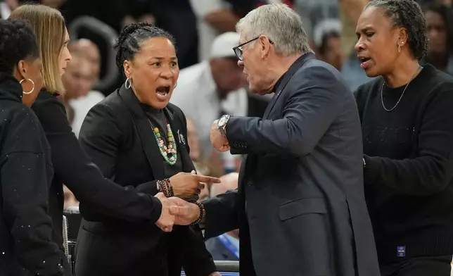 South Carolina head coach Dawn Staley, left, and UConn head coach Geno Auriemma argue after a woman's NCAA college basketball tournament semifinal game at the Final Four, Friday, April 3, 2026, in Phoenix. (AP Photo/Rick Scuteri)