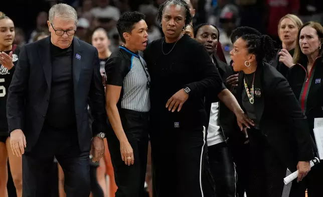 South Carolina head coach Dawn Staley, right, yells at UConn head coach Geno Auriemma, left, after a woman's NCAA college basketball tournament semifinal game at the Final Four, Friday, April 3, 2026, in Phoenix. (AP Photo/Ross D. Franklin)