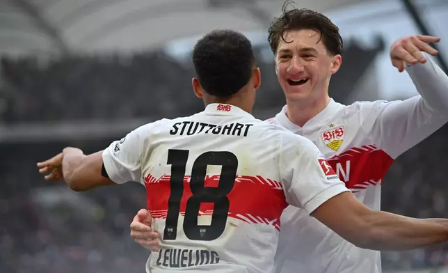 Stuttgart's Angelo Stiller, right, Jamie Leweling celebrates with Jamie Leweling after scoring the opening goal during the German Bundesliga soccer match between VfB Stuttgart and Hamburger SV, in Stuttgart, Germany, Sunday, April 12, 2026. (Katharina Kausche/dpa via AP)