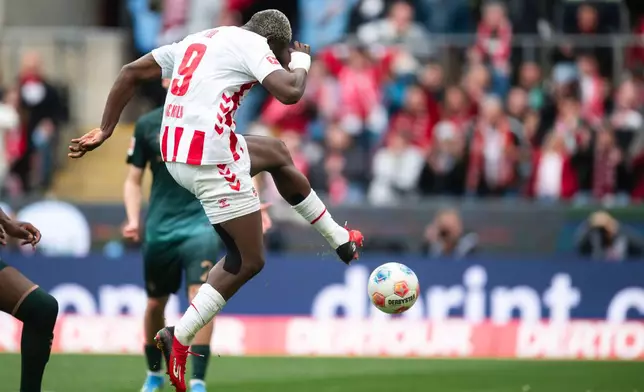 Koln's Ragnar Ache scores his side's second goal during German Bundesliga soccer match between 1. FC Koln and Werder Bremen and Werder Bremen, in Cologne, Germany, Sunday, April 12, 2026. (Marius Becker/dpa via AP)