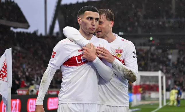 Stuttgart's Bilal El Khannouss, left, celebrates with Maximilian Mittelstädt after scoring his side's fourth goal during the German Bundesliga soccer match between VfB Stuttgart and Hamburger SV, in Stuttgart, Germany, Sunday, April 12, 2026. (Marijan Murat/dpa via AP)