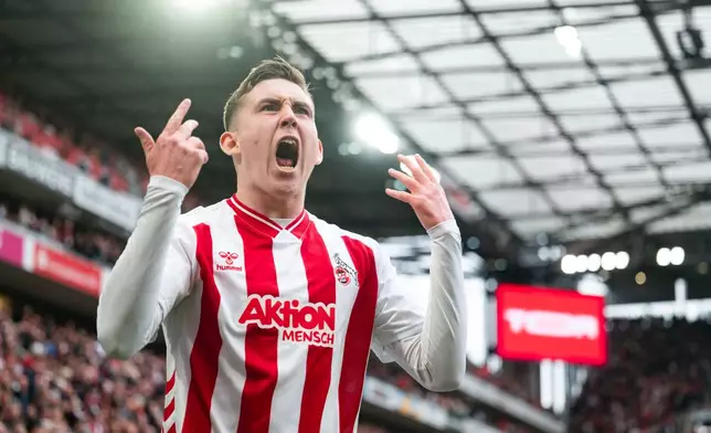 Koln's Isak Johannesson celebrates after scoring his side's third goal during German Bundesliga soccer match between 1. FC Koln and Werder Bremen and Werder Bremen, in Cologne, Germany, Sunday, April 12, 2026. (Marius Becker/dpa via AP)