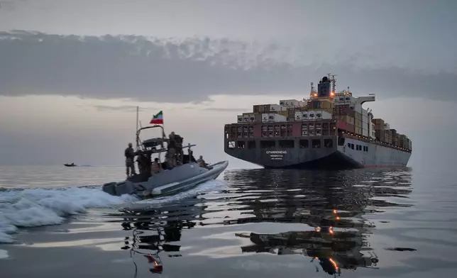 FILE - In this photo released by Tasnim News Agency, a Revolutionary Guard Navy (IRGC) speedboat approaches the cargo ship Epaminondas during what state media described as the seizure of one of two vessels accused of violations in the Strait of Hormuz, April 21, 2026. (Meysam Mirzadeh/Tasnim News Agency via AP, File)
