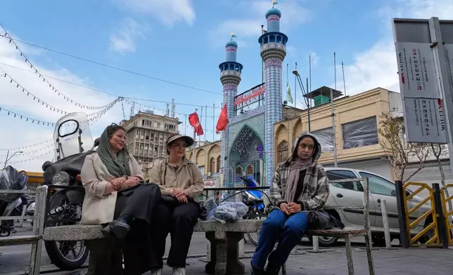 FILE - Women sit in front of a mosque around the traditional grand bazaar of Tehran, Iran, March 29, 2026. (AP Photo/Vahid Salemi, File)