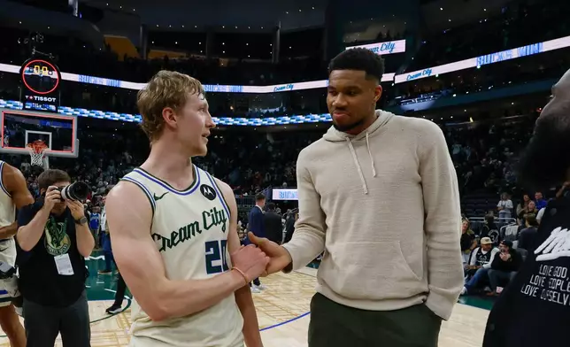 Milwaukee Bucks forward Giannis Antetokounmpo, right, congratulates Milwaukee Bucks guard AJ Green (20) after an NBA basketball game against the Brooklyn Nets, Friday, April 10, 2026, in Milwaukee. (AP Photo/Jeffrey Phelps)