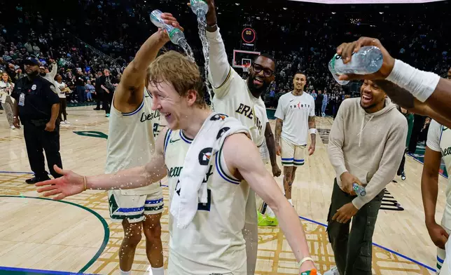 Milwaukee Bucks guard AJ Green (20) is showered with water after an NBA basketball game against the Brooklyn Nets, Friday, April 10, 2026, in Milwaukee. Green set a Bucks franchise record for made three-pointers. (AP Photo/Jeffrey Phelps)