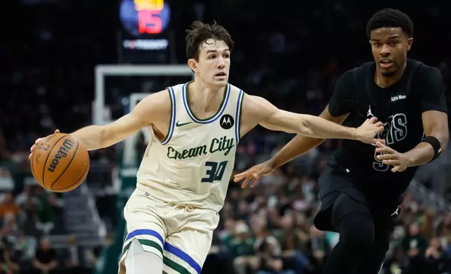 Milwaukee Bucks guard Cormac Ryan (30) drives to the basket in the first half of an NBA basketball game against the Brooklyn Nets, Friday, April 10, 2026, in Milwaukee. (AP Photo/Jeffrey Phelps)