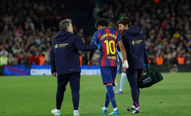 Barcelona's Lamine Yamal leaves the pitch injured during the Spanish La Liga soccer match between Barcelona and Celta Vigo in Barcelona, Spain, Wednesday, April 22, 2026. (AP Photo/Joan Monfort)