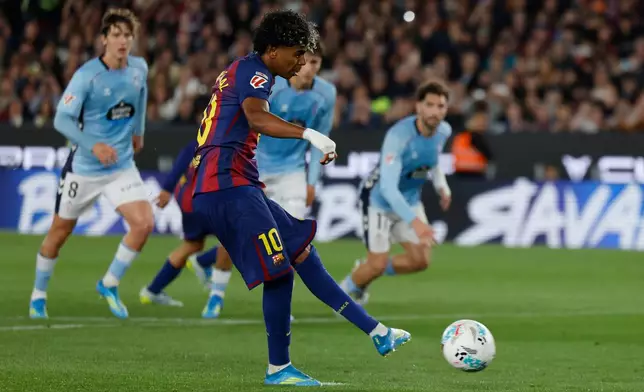 Barcelona's Lamine Yamal scores the opening goal by a penalty during the Spanish La Liga soccer match between Barcelona and Celta Vigo in Barcelona, Spain, Wednesday, April 22, 2026. (AP Photo/Joan Monfort)