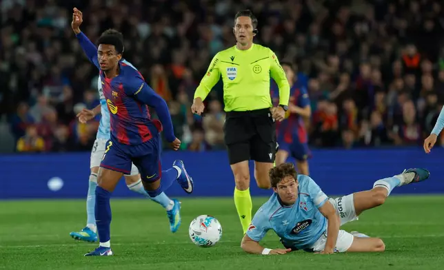 Barcelona's Alejandro Balde, left, and Celta's Marcos Alonso challenge for the ball during the Spanish La Liga soccer match between Barcelona and Celta Vigo in Barcelona, Spain, Wednesday, April 22, 2026. (AP Photo/Joan Monfort)