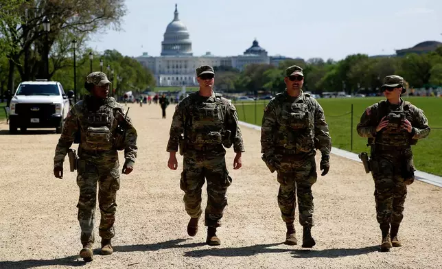 National Guard patrol the Washington Mall, with the U.S. Capitol in the background, Tuesday, April 7, 2026, in Washington. (AP Photo/Rahmat Gul)